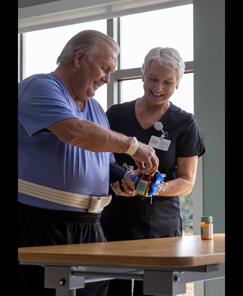 Patient and a nurse using technology to open a bottle