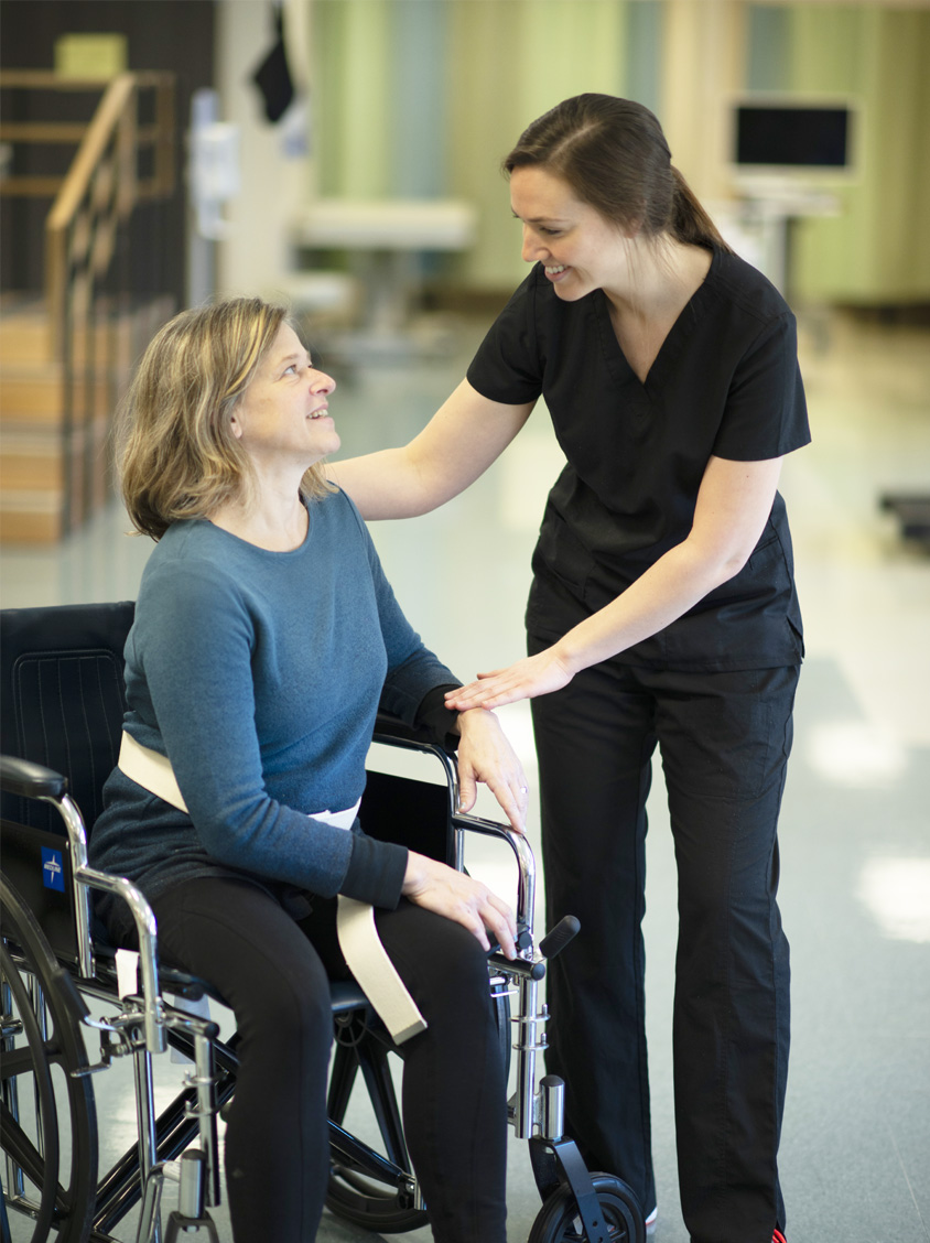 Nurse speaking with patient in a wheelchair